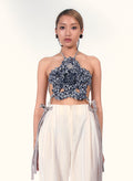 Woman wearing a floral indigo crochet halter cop top