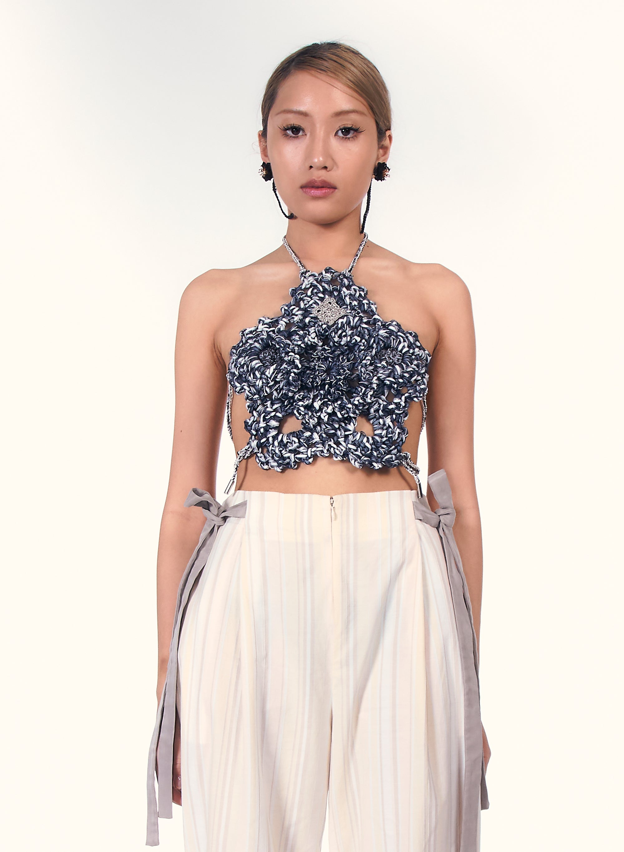 Woman wearing a floral indigo crochet halter cop top